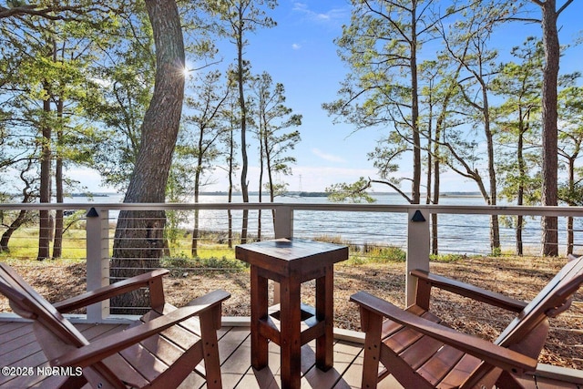 wooden terrace featuring a water view
