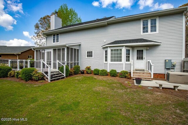 138 Stonebridge Trl, Havelock, NC 28532 - rear view of house with a yard, entry steps, a wooden deck, a chimney, and a sunroom