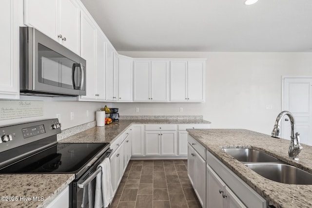 kitchen featuring a sink, white cabinets, and stainless steel appliances
