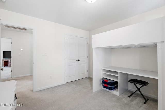 unfurnished office featuring visible vents, baseboards, and carpet floors