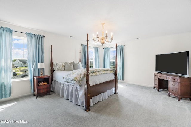 carpeted bedroom with a chandelier and baseboards