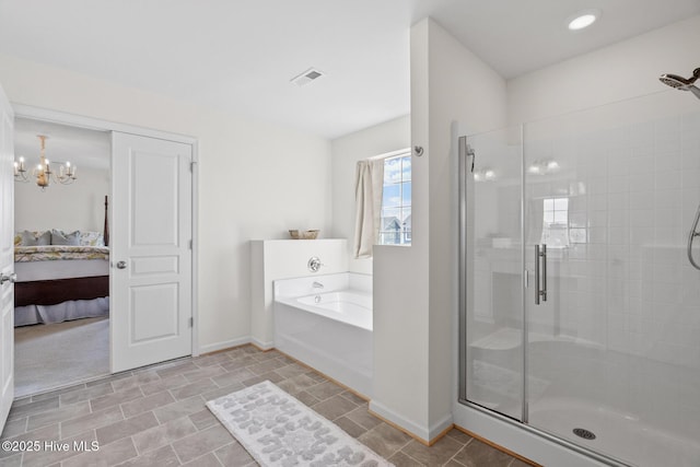 ensuite bathroom with a stall shower, ensuite bathroom, baseboards, and visible vents