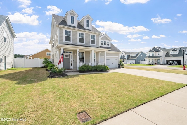 traditional-style home featuring concrete driveway, a front lawn, a garage, fence, and covered porch
