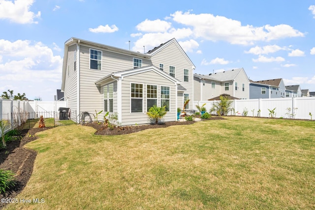 back of property featuring a yard, a fenced backyard, central AC unit, and a residential view