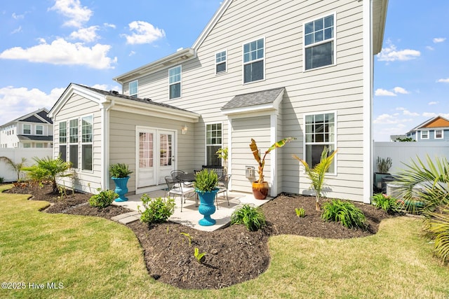 rear view of property with a patio area, fence, and a yard