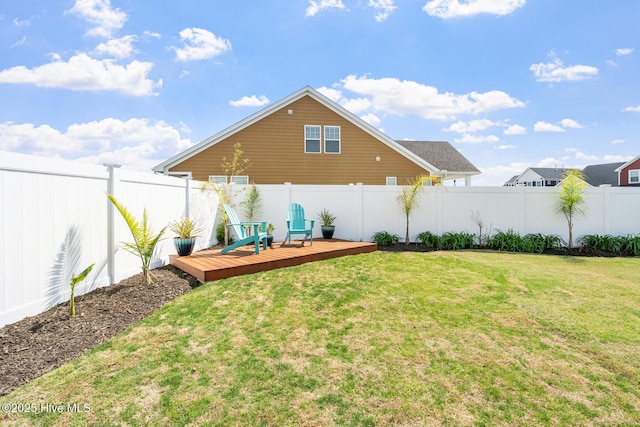 view of yard with a fenced backyard and a wooden deck