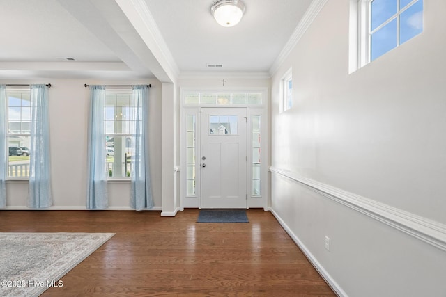 foyer entrance with ornamental molding, visible vents, baseboards, and wood finished floors