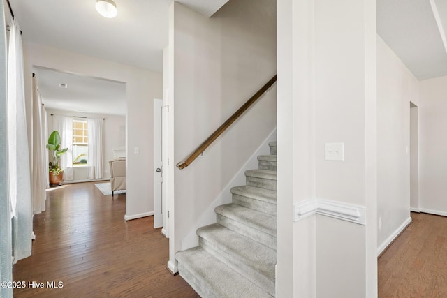 stairway featuring wood finished floors and baseboards