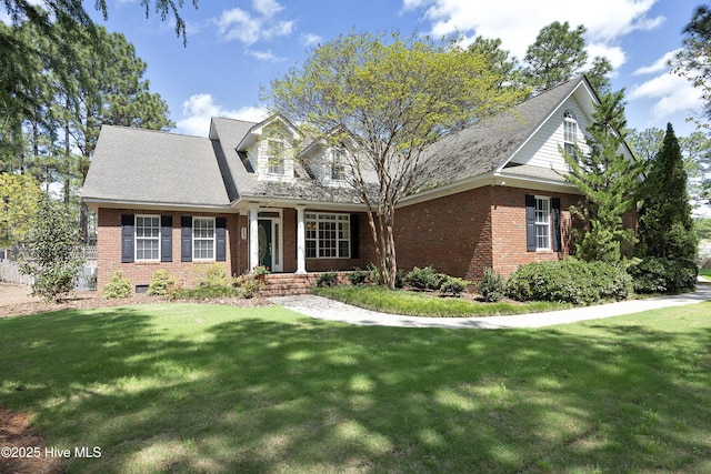 995 Monticello Dr, Pinehurst, NC 28374 - cape cod home featuring brick siding and a front lawn