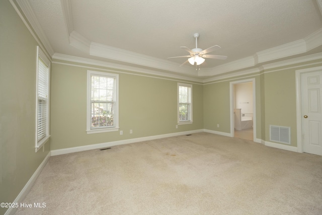 995 Monticello Dr, Pinehurst, NC 28374 - unfurnished bedroom featuring a raised ceiling, ornamental molding, light carpet, baseboards, and connected bathroom