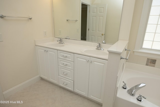 995 Monticello Dr, Pinehurst, NC 28374 - bathroom with double vanity, a bath, tile patterned flooring, and baseboards