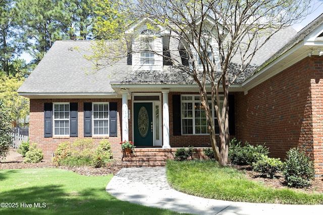 995 Monticello Dr, Pinehurst, NC 28374 - view of front facade with brick siding, roof with shingles, and a front yard