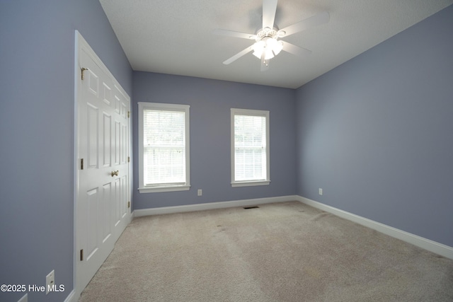 995 Monticello Dr, Pinehurst, NC 28374 - empty room with light colored carpet, baseboards, and a ceiling fan
