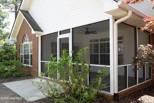 995 Monticello Dr, Pinehurst, NC 28374 - view of side of property featuring a sunroom, brick siding, and a shingled roof