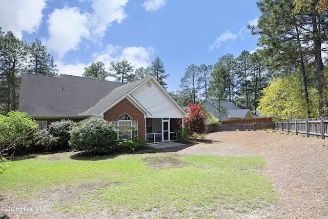 995 Monticello Dr, Pinehurst, NC 28374 - view of front facade featuring a sunroom and brick siding