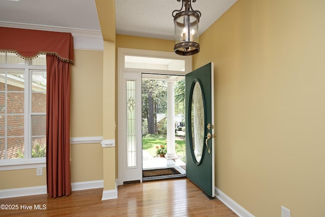 995 Monticello Dr, Pinehurst, NC 28374 - entrance foyer featuring plenty of natural light, wood finished floors, baseboards, and a textured ceiling