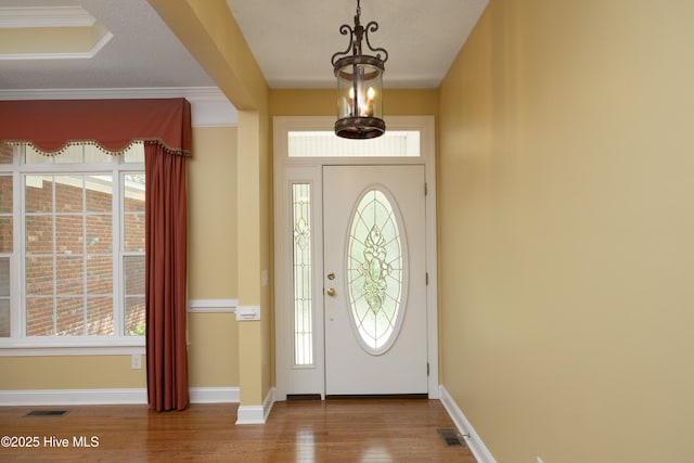 995 Monticello Dr, Pinehurst, NC 28374 - foyer with wood finished floors, healthy amount of natural light, baseboards, and crown molding