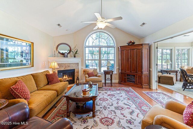 105 W Chelsea Ct, Southern Pines, NC 28387 - living room with a tile fireplace, visible vents, a ceiling fan, and light wood-style flooring