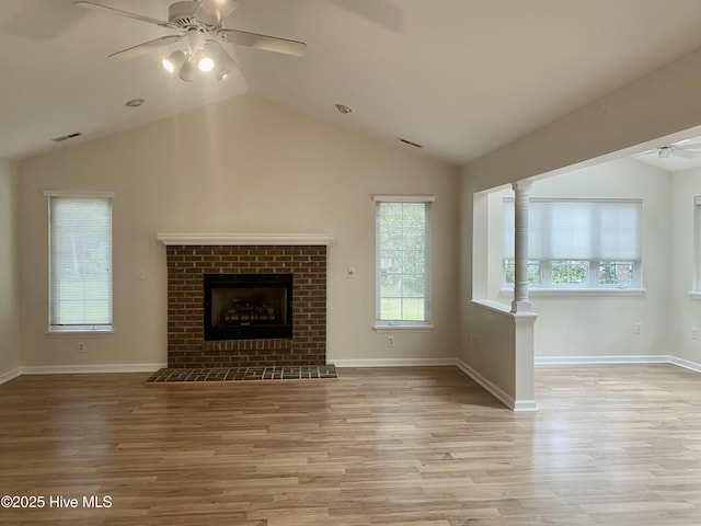 unfurnished living room with a ceiling fan, visible vents, wood finished floors, and lofted ceiling