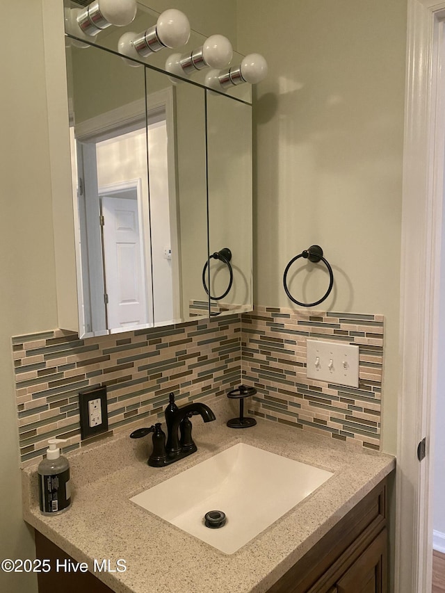 bathroom with vanity and tasteful backsplash