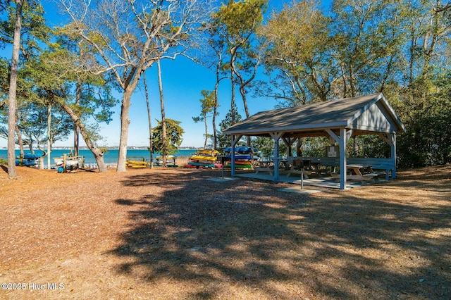 surrounding community featuring a water view and a gazebo