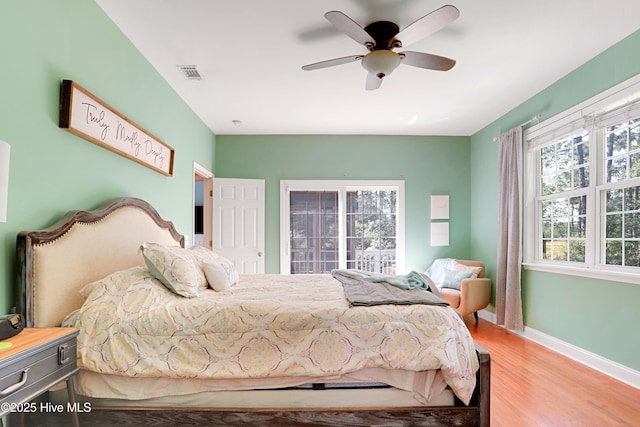 161 N Lake Dr, Boiling Spring Lakes, NC 28461 - bedroom with visible vents, baseboards, ceiling fan, and wood finished floors