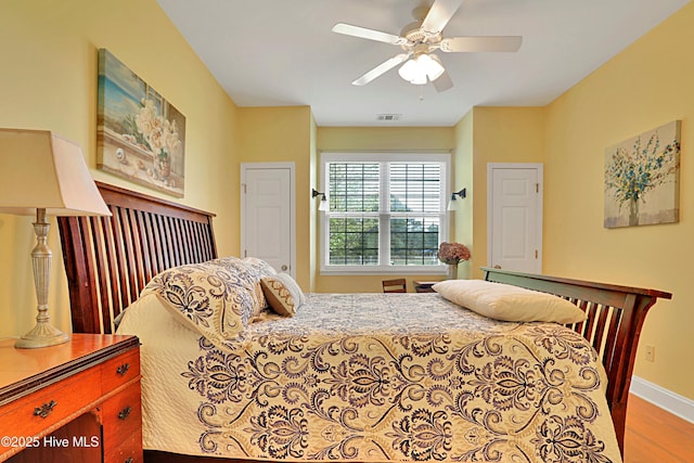 161 N Lake Dr, Boiling Spring Lakes, NC 28461 - bedroom with ceiling fan, baseboards, visible vents, and wood finished floors