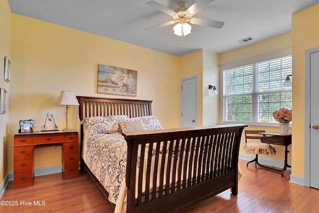 161 N Lake Dr, Boiling Spring Lakes, NC 28461 - bedroom with visible vents, baseboards, ceiling fan, and hardwood / wood-style flooring