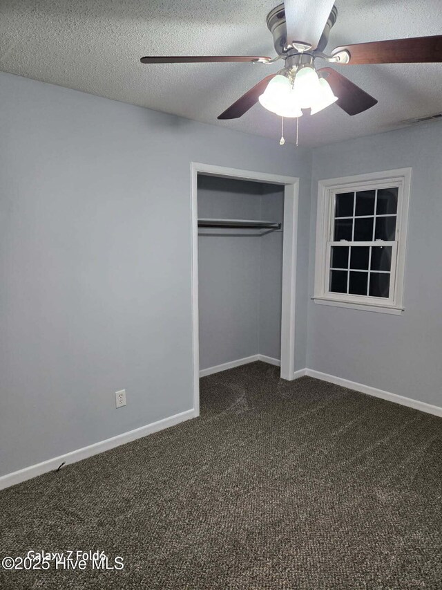100 Knight Pl, Jacksonville, NC 28546 - unfurnished bedroom with dark colored carpet, a closet, a textured ceiling, a ceiling fan, and baseboards