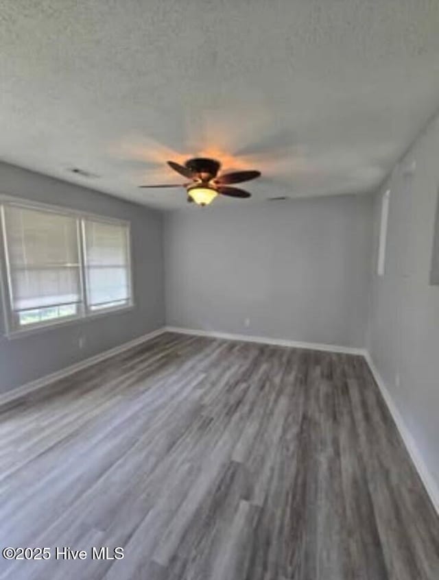 100 Knight Pl, Jacksonville, NC 28546 - empty room with wood finished floors, baseboards, and a ceiling fan
