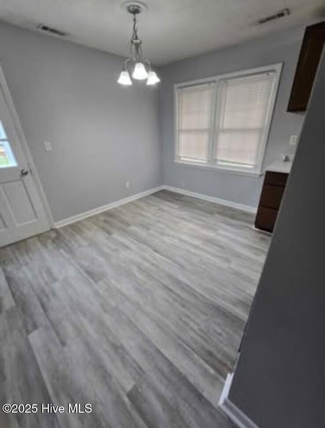 100 Knight Pl, Jacksonville, NC 28546 - unfurnished dining area with plenty of natural light, baseboards, and wood finished floors