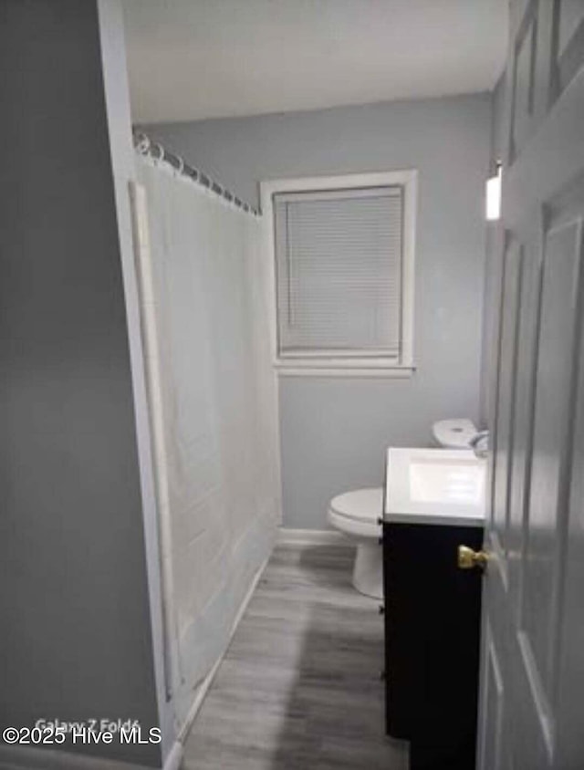 100 Knight Pl, Jacksonville, NC 28546 - bathroom with vanity, toilet, wood finished floors, and baseboards