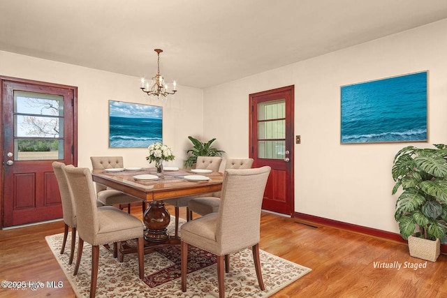 921 Greenfield Heights Blvd, Havelock, NC 28532 - dining space featuring a chandelier, wood finished floors, and baseboards