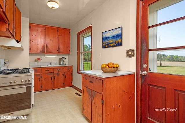 921 Greenfield Heights Blvd, Havelock, NC 28532 - kitchen with stainless steel gas range oven, under cabinet range hood, light countertops, a sink, and light flooring