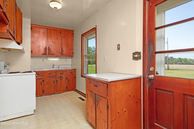 921 Greenfield Heights Blvd, Havelock, NC 28532 - kitchen featuring stove, under cabinet range hood, a sink, light flooring, and light countertops