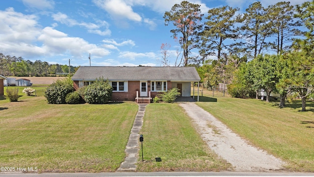 921 Greenfield Heights Blvd, Havelock, NC 28532 - view of front facade featuring driveway, brick siding, a front lawn, a carport, and crawl space