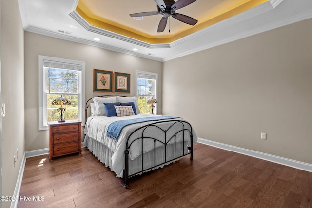 8549 Oak Abbey Trl NE, Leland, NC 28451 - bedroom featuring dark wood-style floors, a raised ceiling, baseboards, visible vents, and ornamental molding