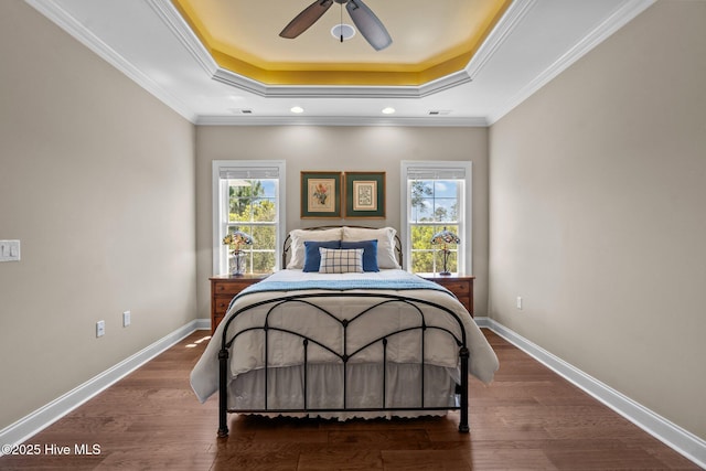 8549 Oak Abbey Trl NE, Leland, NC 28451 - bedroom featuring a raised ceiling, wood finished floors, baseboards, and multiple windows