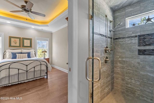 8549 Oak Abbey Trl NE, Leland, NC 28451 - bedroom featuring a tray ceiling, baseboards, wood finished floors, ceiling fan, and ornamental molding