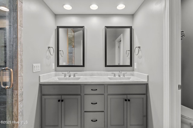 8549 Oak Abbey Trl NE, Leland, NC 28451 - full bathroom featuring double vanity, toilet, a stall shower, and a sink