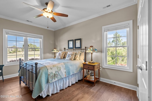 8549 Oak Abbey Trl NE, Leland, NC 28451 - bedroom with wood finished floors, visible vents, crown molding, and baseboards