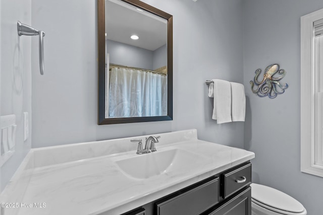 8549 Oak Abbey Trl NE, Leland, NC 28451 - bathroom featuring vanity, a shower with shower curtain, and toilet