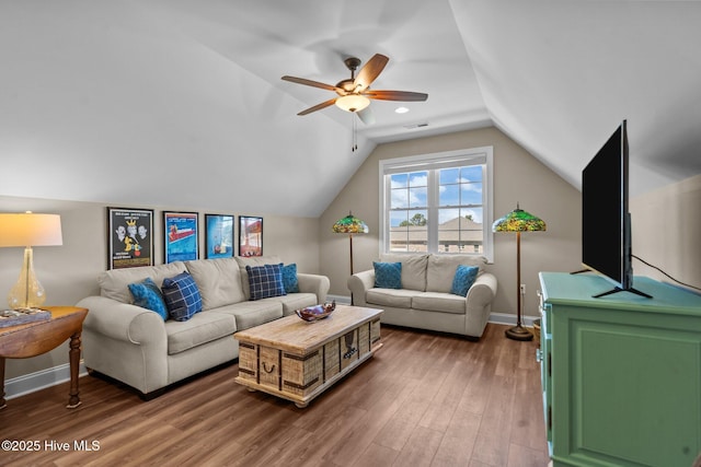 8549 Oak Abbey Trl NE, Leland, NC 28451 - living room with lofted ceiling, wood finished floors, visible vents, baseboards, and ceiling fan