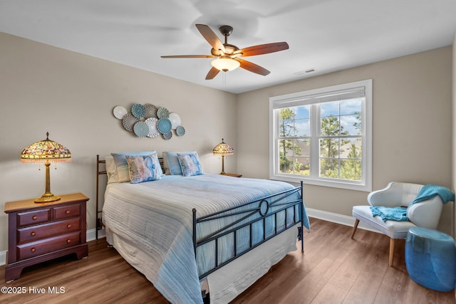 8549 Oak Abbey Trl NE, Leland, NC 28451 - bedroom with visible vents, wood finished floors, baseboards, and ceiling fan