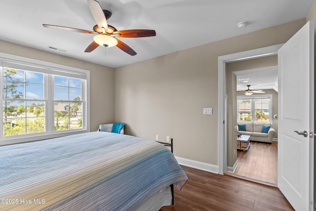 8549 Oak Abbey Trl NE, Leland, NC 28451 - bedroom featuring visible vents, baseboards, ceiling fan, and dark wood-style flooring