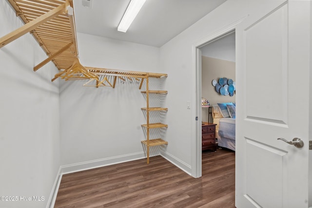 8549 Oak Abbey Trl NE, Leland, NC 28451 - spacious closet featuring dark wood finished floors and visible vents