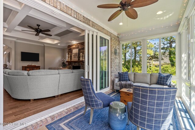 8549 Oak Abbey Trl NE, Leland, NC 28451 - sunroom / solarium featuring an outdoor living space with a fireplace and a ceiling fan