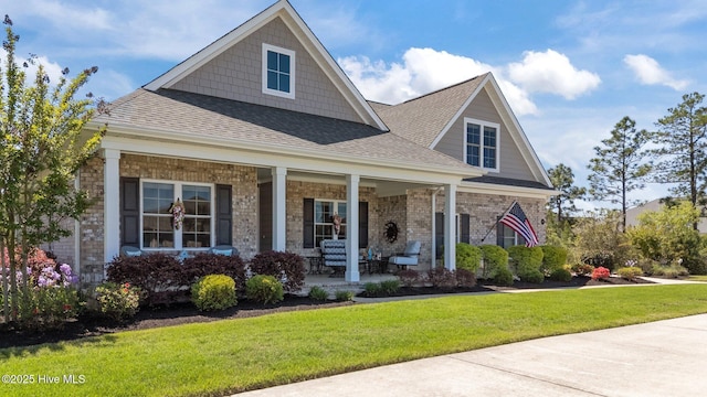 8549 Oak Abbey Trl NE, Leland, NC 28451 - craftsman inspired home featuring a porch, a shingled roof, and a front yard