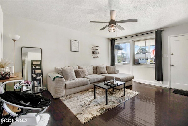 living room featuring ceiling fan, hardwood / wood-style flooring, and a textured ceiling