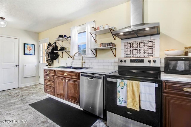 kitchen featuring open shelves, a wealth of natural light, wall chimney exhaust hood, stainless steel appliances, and a sink